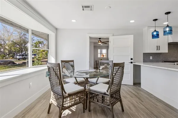 a dining room with furniture and window