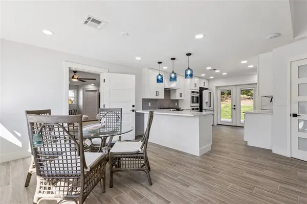 a view of a dining room with furniture and wooden floor