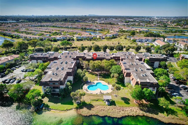 an aerial view of house with yard and ocean view