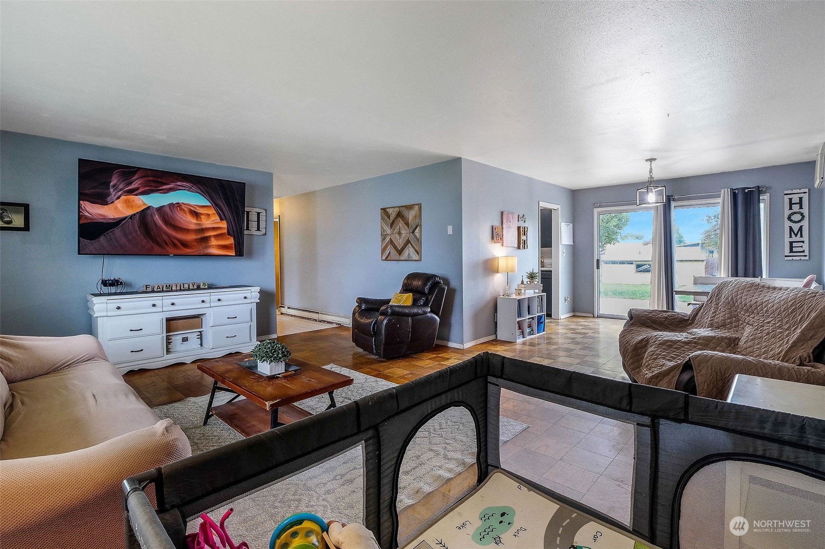 9012 B Bong Loop Moses Lake, WA 98837 - Photo 6 of 30 a living room with furniture a flat screen tv and a fireplace