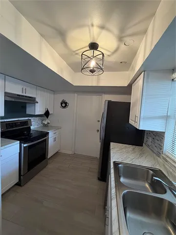 a kitchen with a refrigerator and a sink
