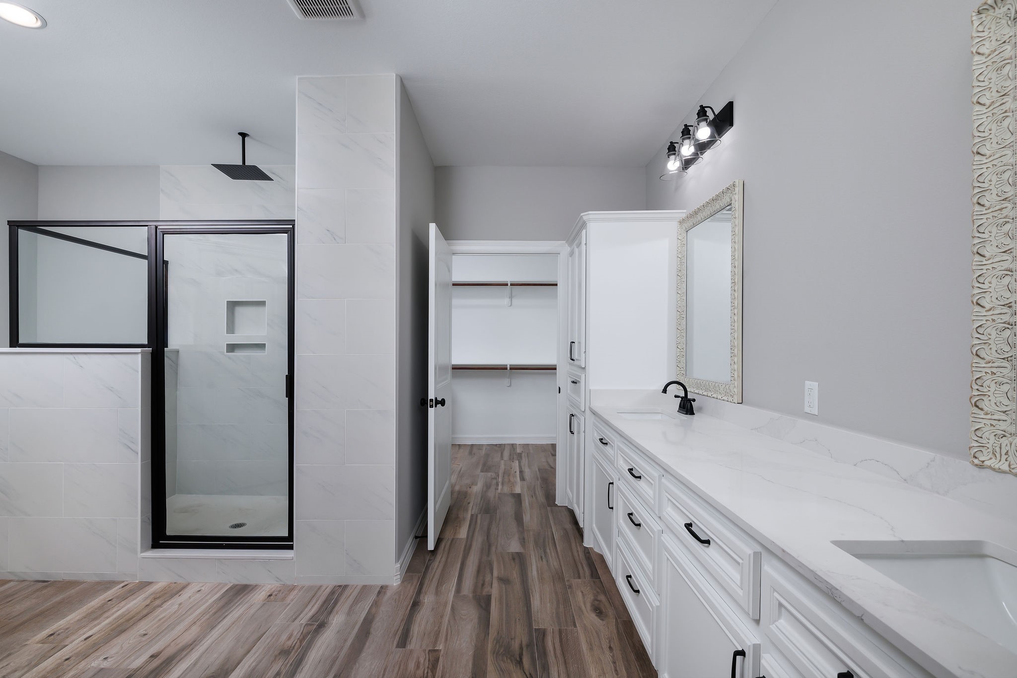 364 Dahlia Road Huntsville, TX 77320 - Photo 24 of 34 a bathroom with a double vanity sink and mirror