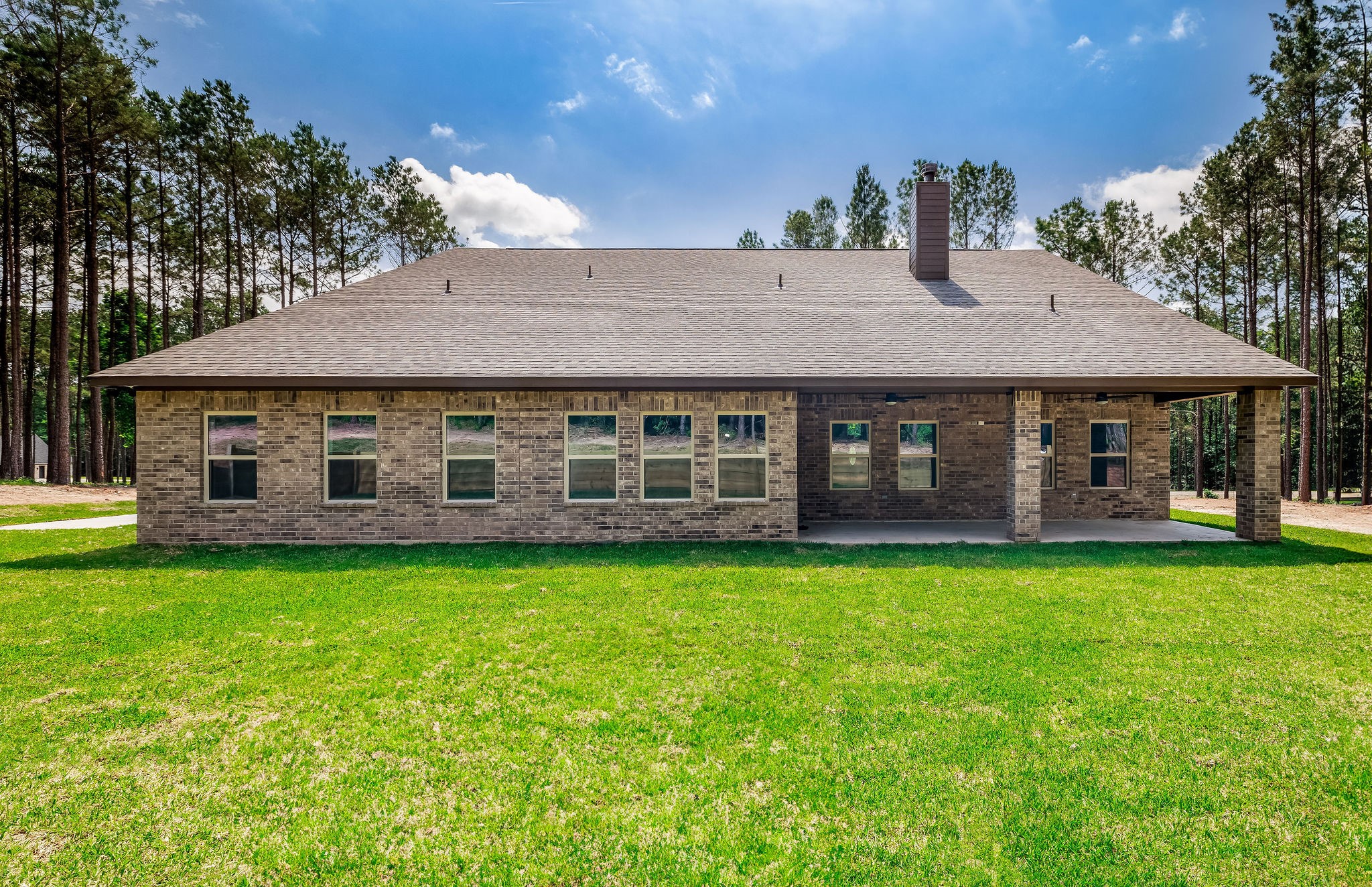 364 Dahlia Road Huntsville, TX 77320 - Photo 32 of 34 a front view of a house with a garden