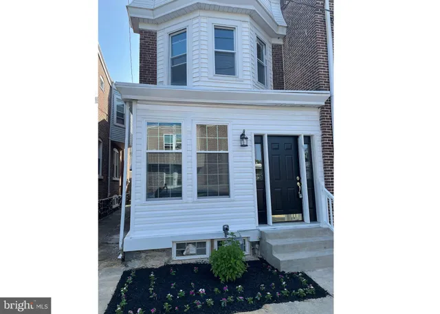 a view of a house with potted plants