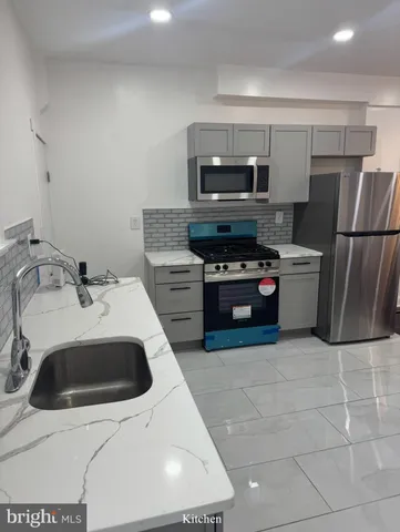 a kitchen with a sink a stove and refrigerator