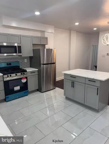 a kitchen with stainless steel appliances a refrigerator sink and cabinets