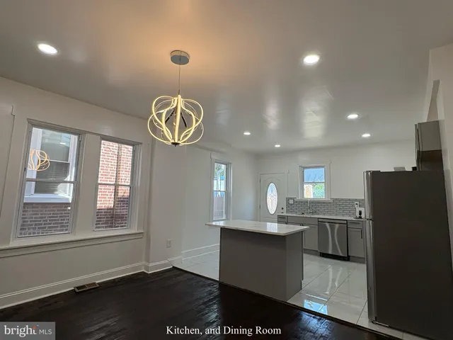 a view of kitchen with window and refrigerator