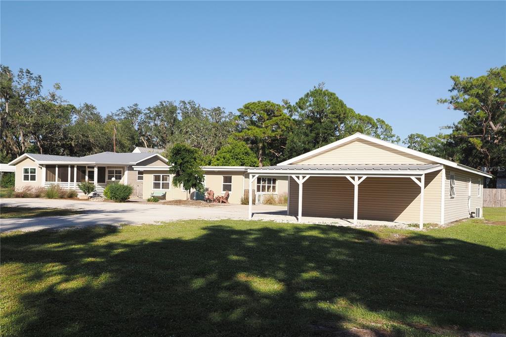 1303 Arcadia Avenue Sarasota, FL 34232 - Photo 1 of 1 a front view of a house with a yard