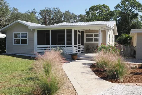 a front view of a house with a yard and outdoor seating