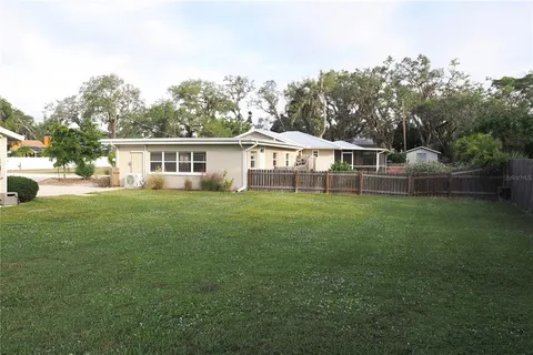 a view of a house with a backyard and a patio
