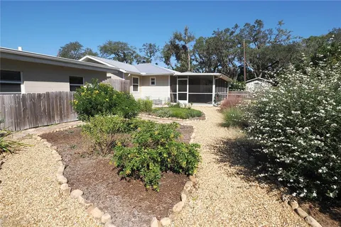 a living room with furniture a large window and a flat screen tv
