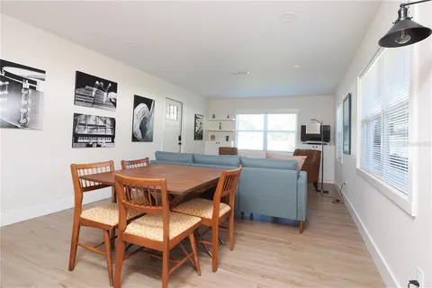a kitchen with stainless steel appliances a sink cabinets and wooden floor