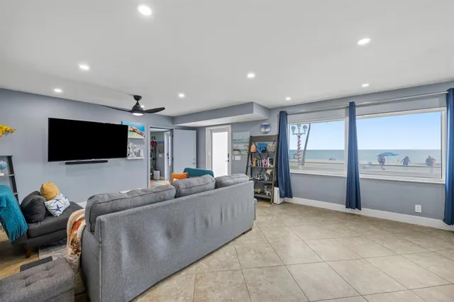 a bedroom with a bed a lamp and a flat tv screen