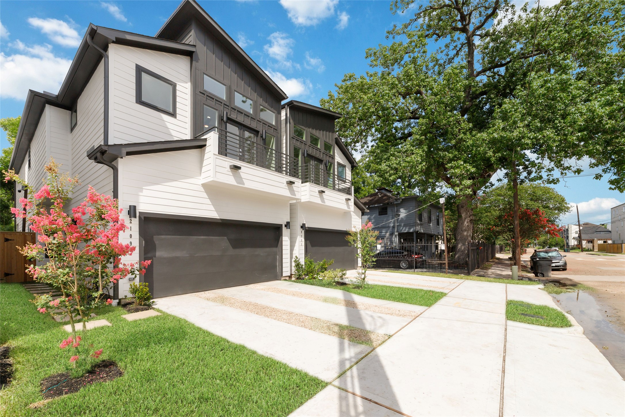 2109 Holman Street Houston, TX 77004 - Photo 3 of 30 Side View of This First Floor Living Home Complemented by well-maintained Landscaping and Vibrant Trees