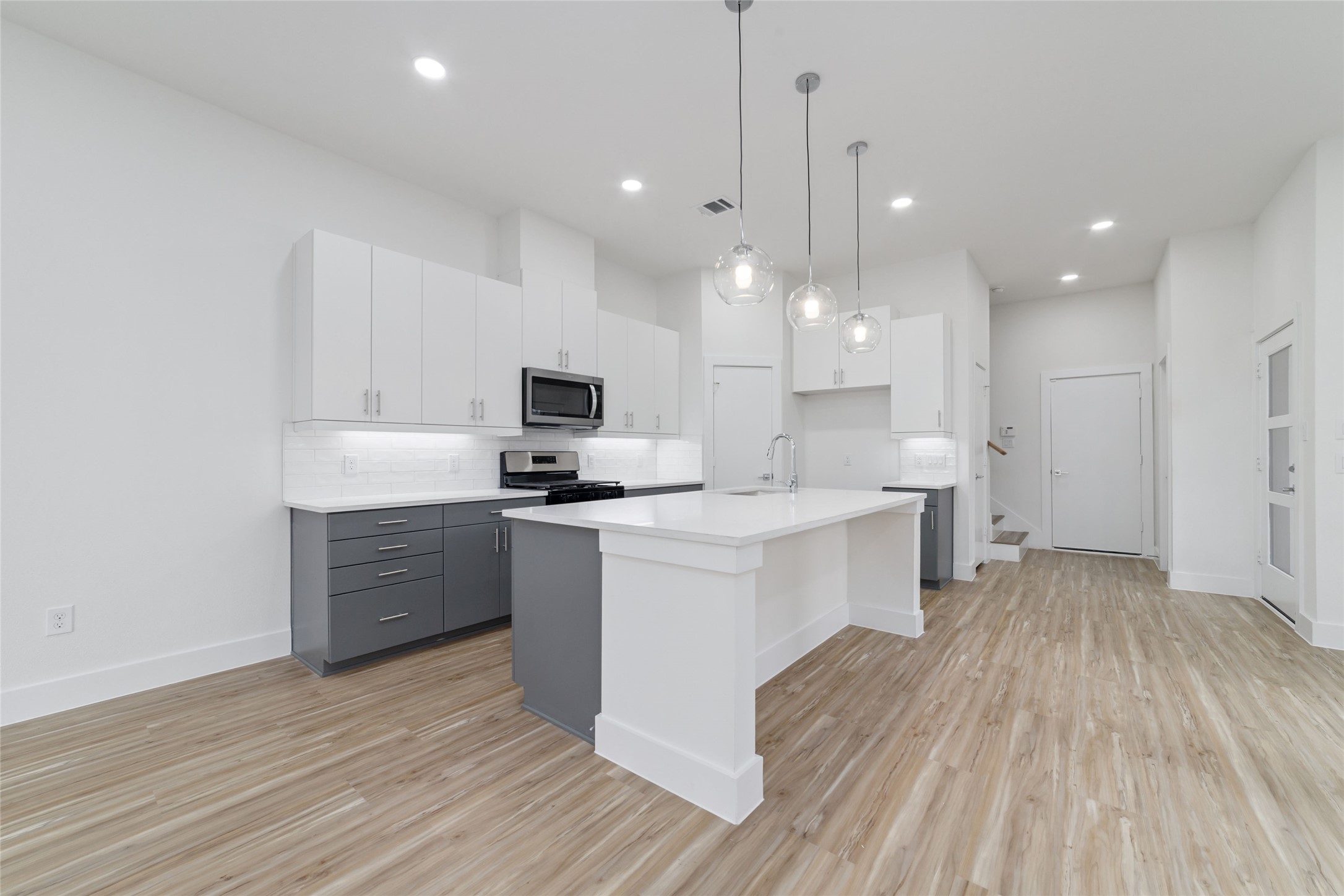 2109 Holman Street Houston, TX 77004 - Photo 7 of 30 Stunning Light Features Showcasing the HUGE Kitchen Island