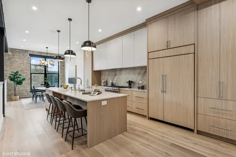 a kitchen with kitchen island a stove a sink a center island and a refrigerator