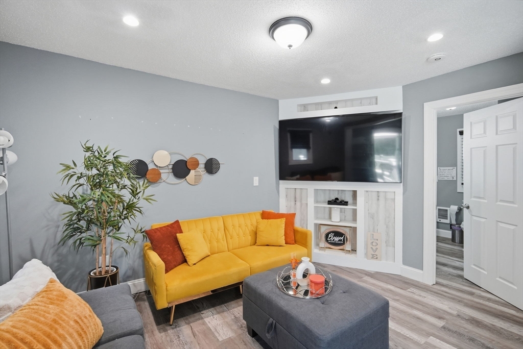 72 Switzer Avenue Springfield, MA 01109 - Photo 23 of 37 a living room with furniture and a flat screen tv