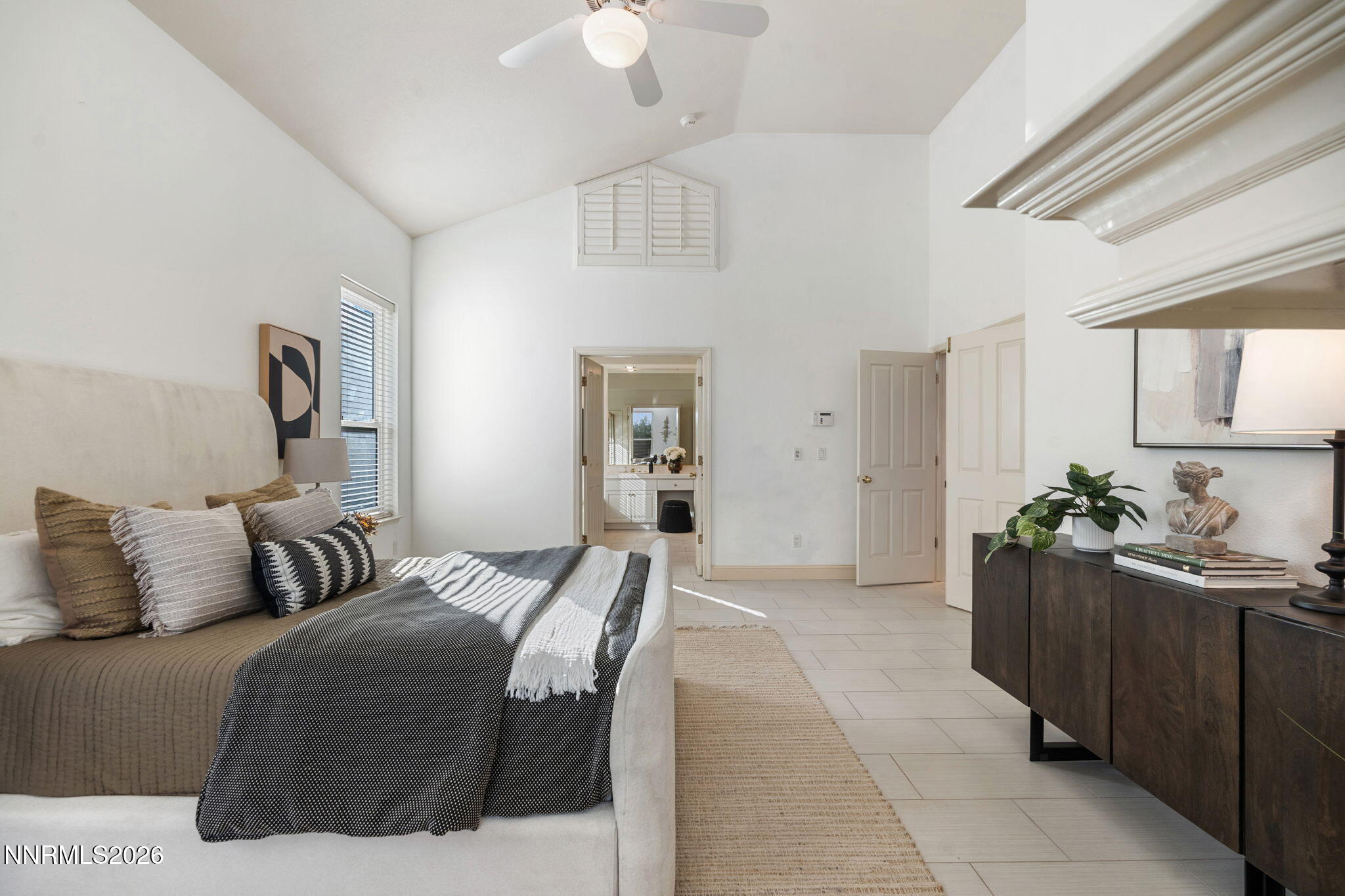 6186 Squires Lane Reno, NV 89519 - Photo 26 of 57 a bedroom with a bed and ceiling fan