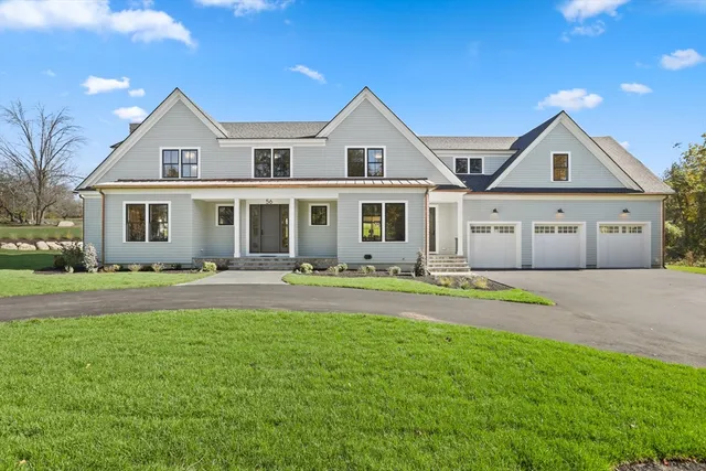 a front view of a house with a garden and yard