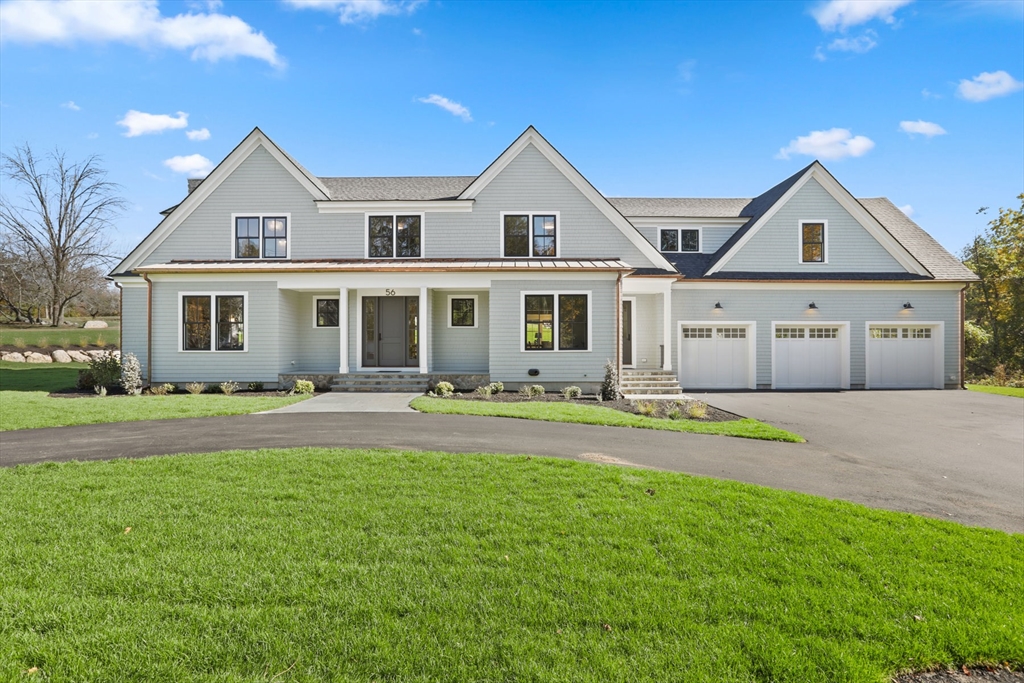 56 Sunset Rock Road Andover, MA 01810 - Photo 1 of 42 a front view of a house with a garden and yard