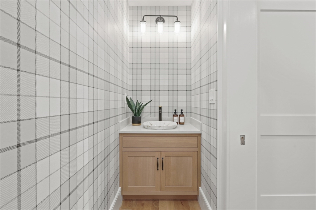 56 Sunset Rock Road Andover, MA 01810 - Photo 11 of 42 a bathroom with a sink a vanity and a mirror
