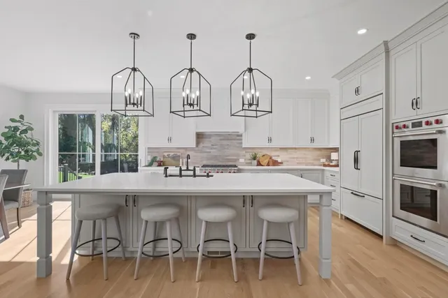 a kitchen with cabinets and chairs