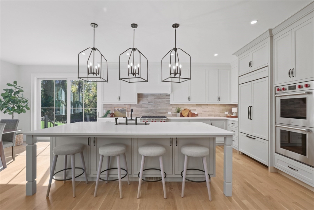 56 Sunset Rock Road Andover, MA 01810 - Photo 12 of 42 a kitchen with cabinets and chairs