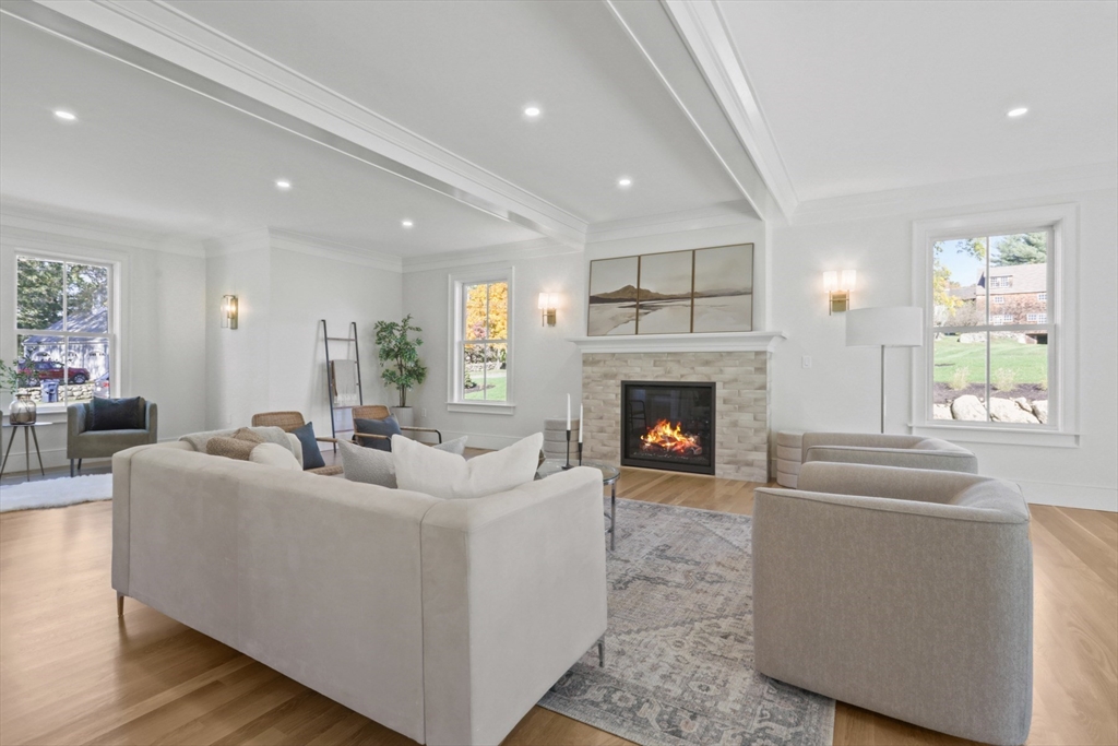 56 Sunset Rock Road Andover, MA 01810 - Photo 19 of 42 a living room with furniture a fireplace and a large window