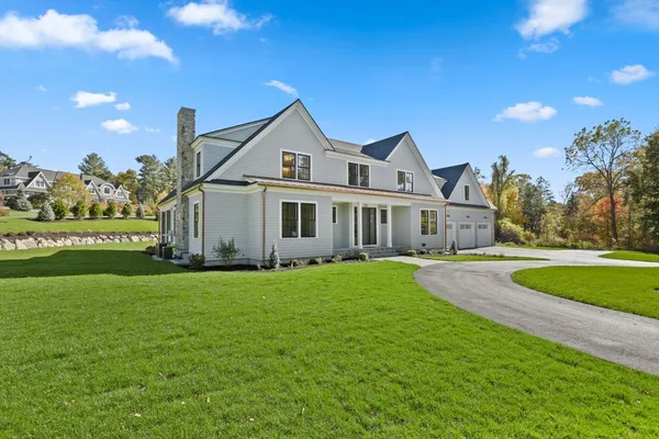 a front view of a house with yard and green space