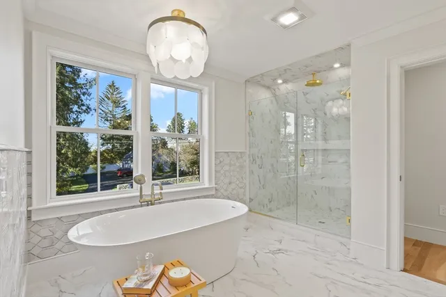 a bathroom with a granite countertop sink a large mirror and a large window