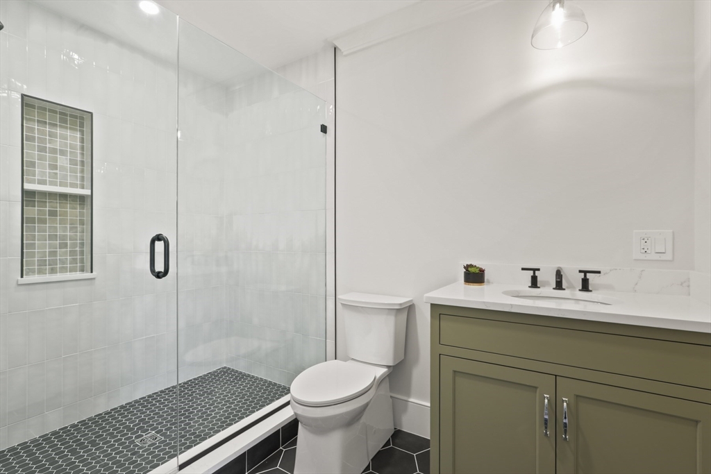 56 Sunset Rock Road Andover, MA 01810 - Photo 28 of 42 a bathroom with a sink toilet and shower