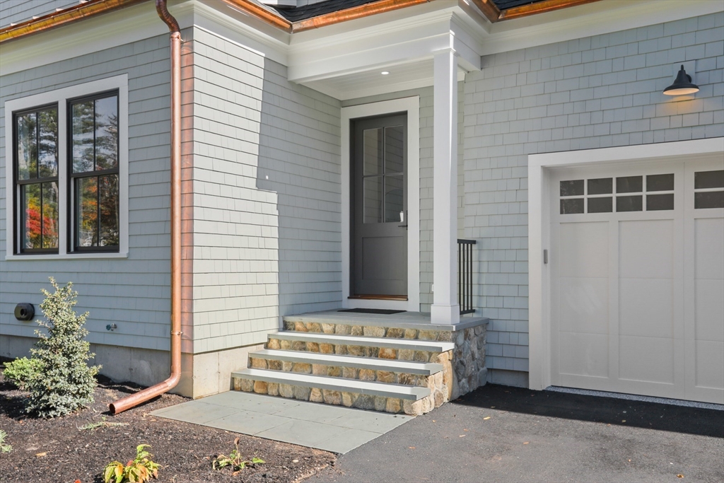 56 Sunset Rock Road Andover, MA 01810 - Photo 3 of 42 a front view of a house with a garage