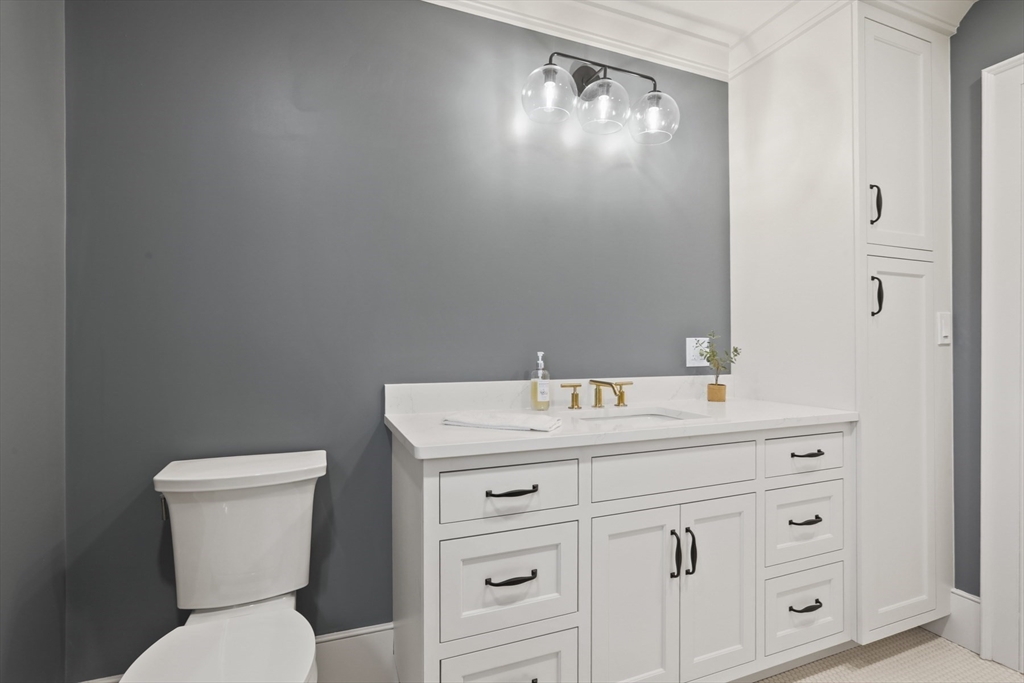 56 Sunset Rock Road Andover, MA 01810 - Photo 31 of 42 a bathroom with a toilet sink and mirror