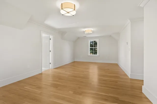 a spacious bathroom with a granite countertop sink a mirror and a shower