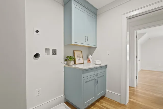 a view of a kitchen with refrigerator and a stove top oven