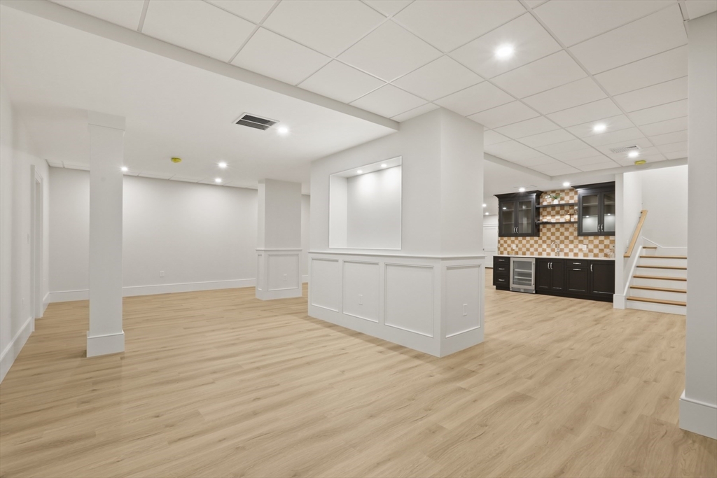 56 Sunset Rock Road Andover, MA 01810 - Photo 37 of 42 a view of a kitchen with refrigerator and a stove top oven