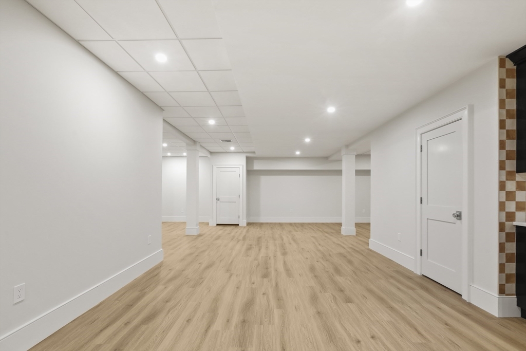 56 Sunset Rock Road Andover, MA 01810 - Photo 40 of 42 a view of an empty room with wooden floor