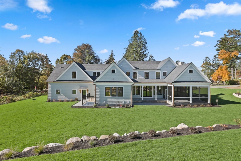 56 Sunset Rock Road Andover, MA 01810 - Photo 4 of 42 a front view of a house with a garden and trees