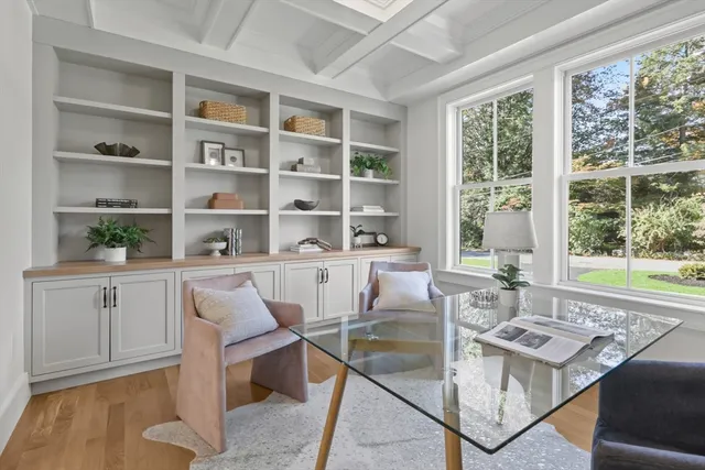 a dining room with wooden floor and a window