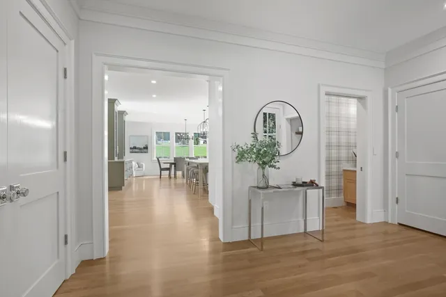 a view of a living room and a dining room with wooden floor