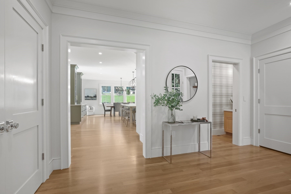 56 Sunset Rock Road Andover, MA 01810 - Photo 10 of 42 a view of a living room and a dining room with wooden floor