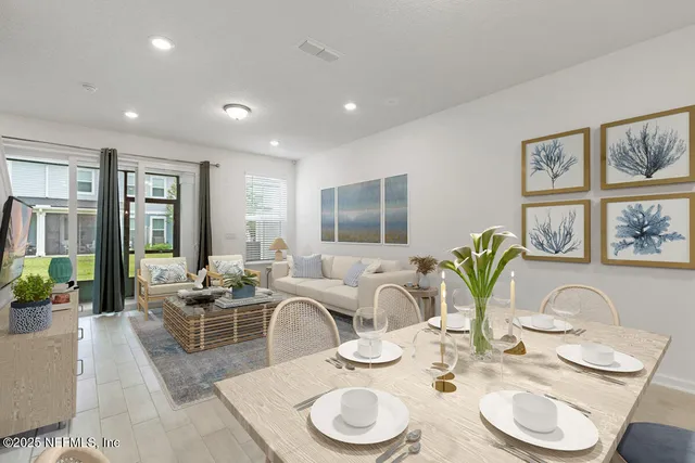 a dining room with furniture a large window and wooden floor