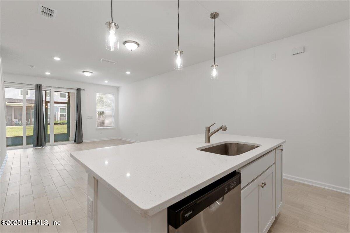 39 Thurnham Lane St. Augustine, FL 32092 - Photo 9 of 52 a kitchen with a sink a center island and appliances