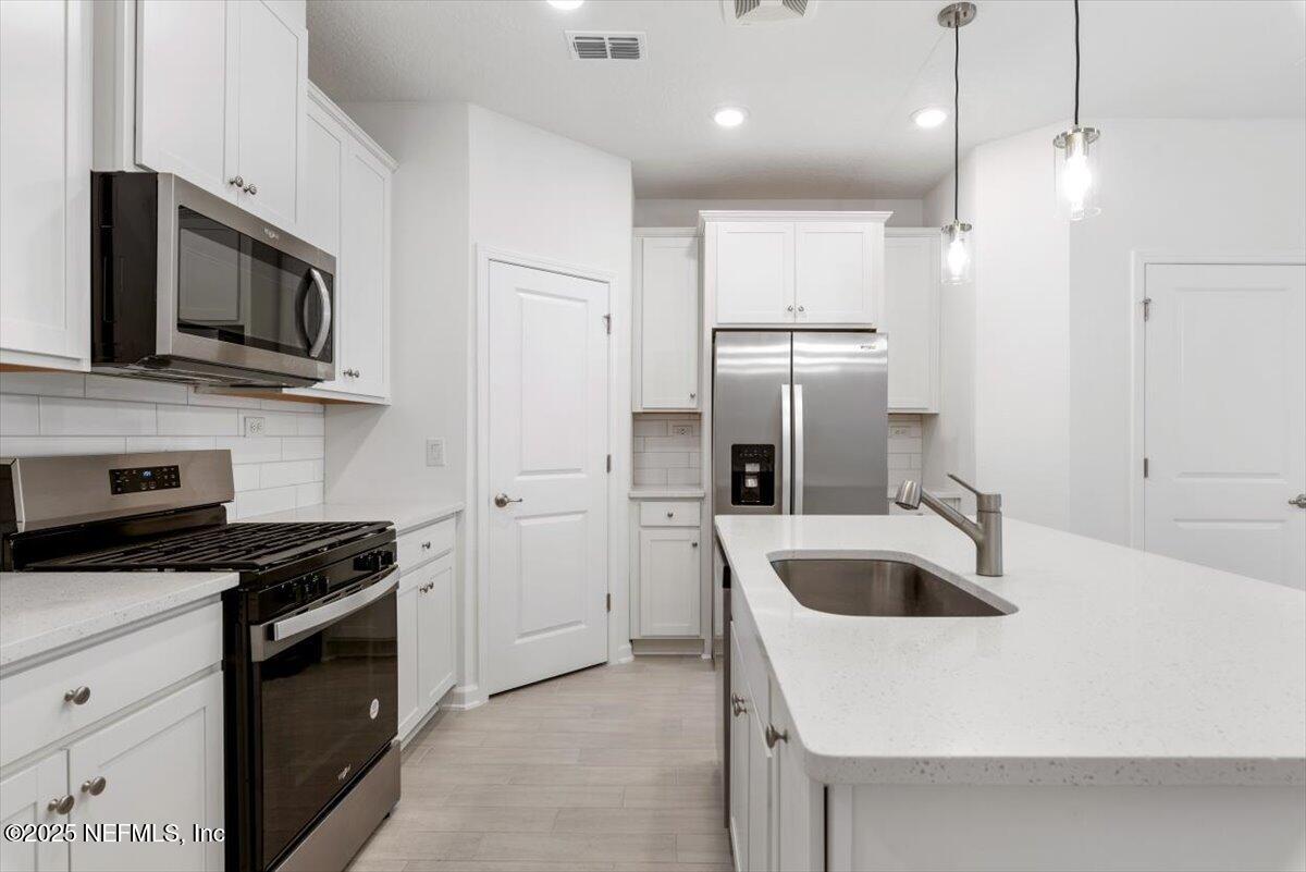 39 Thurnham Lane St. Augustine, FL 32092 - Photo 10 of 52 a kitchen with granite countertop a sink and stainless steel appliances
