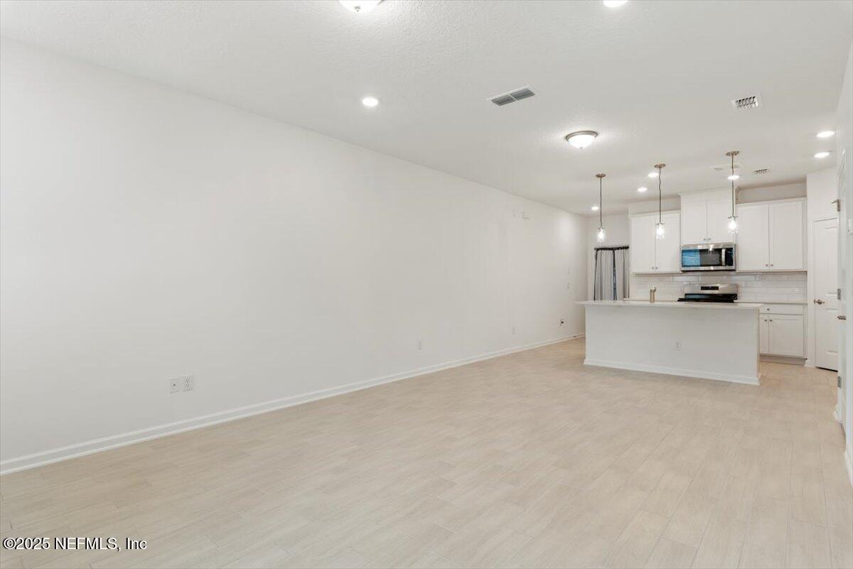 39 Thurnham Lane St. Augustine, FL 32092 - Photo 17 of 52 a view of kitchen with kitchen island white cabinets and refrigerator