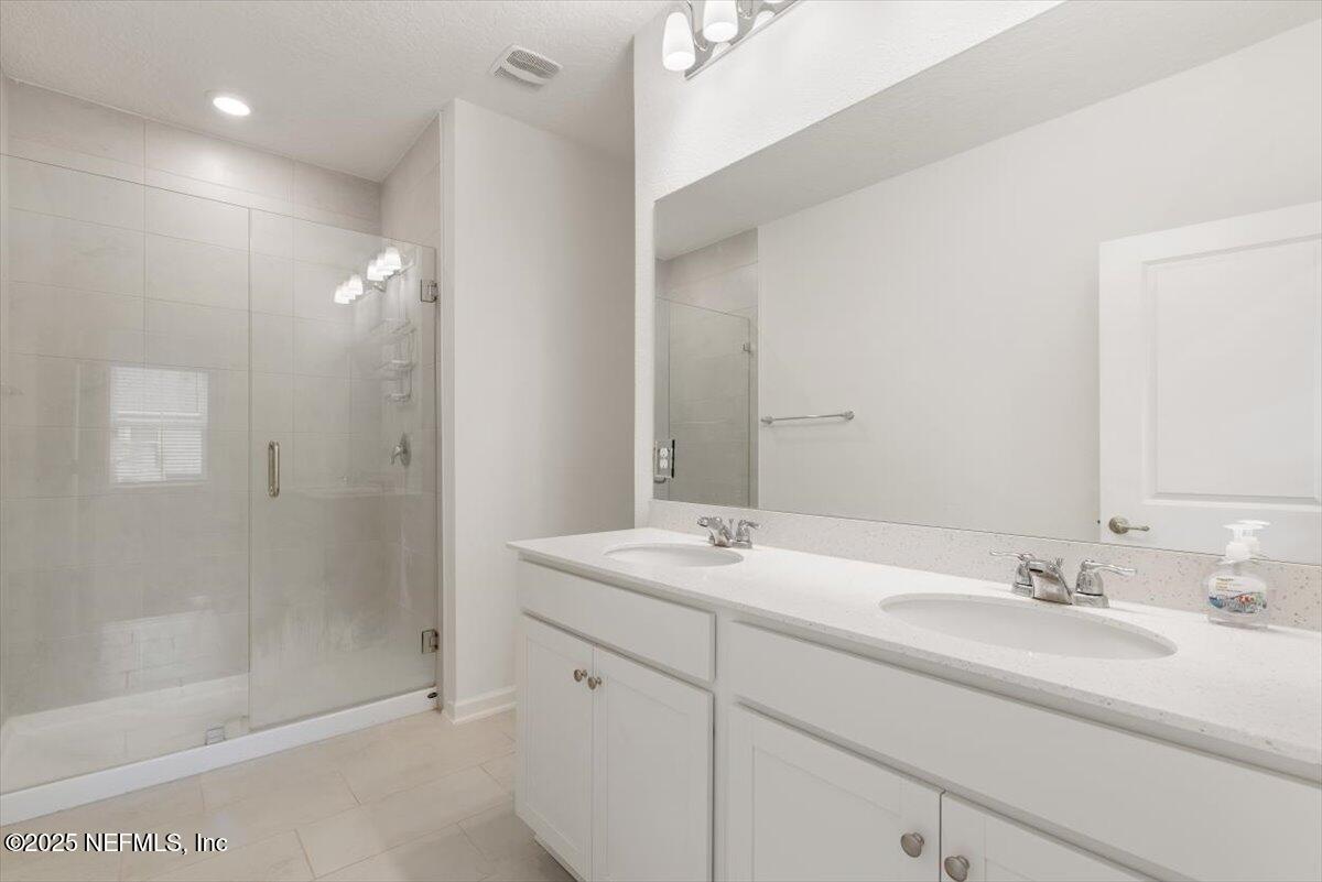 39 Thurnham Lane St. Augustine, FL 32092 - Photo 25 of 52 a bathroom with a sink double vanity and shower