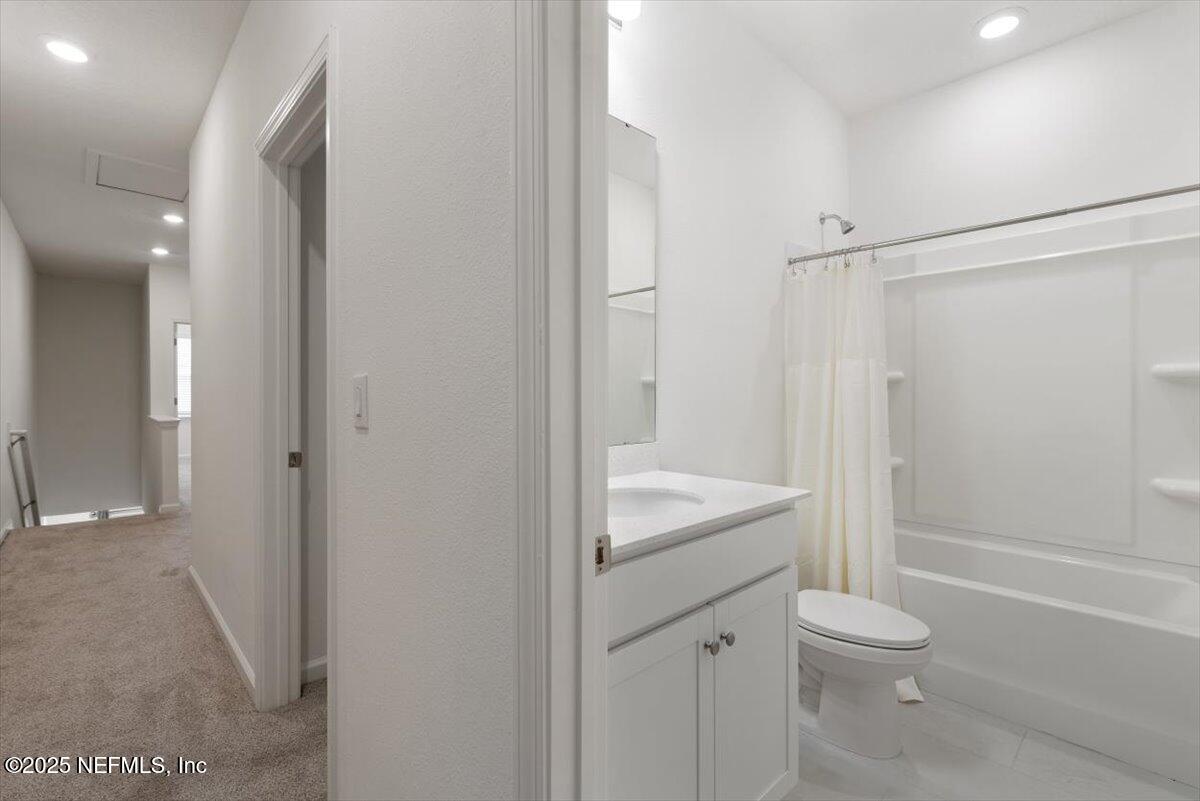 39 Thurnham Lane St. Augustine, FL 32092 - Photo 32 of 52 a bathroom with a granite countertop toilet a sink and shower