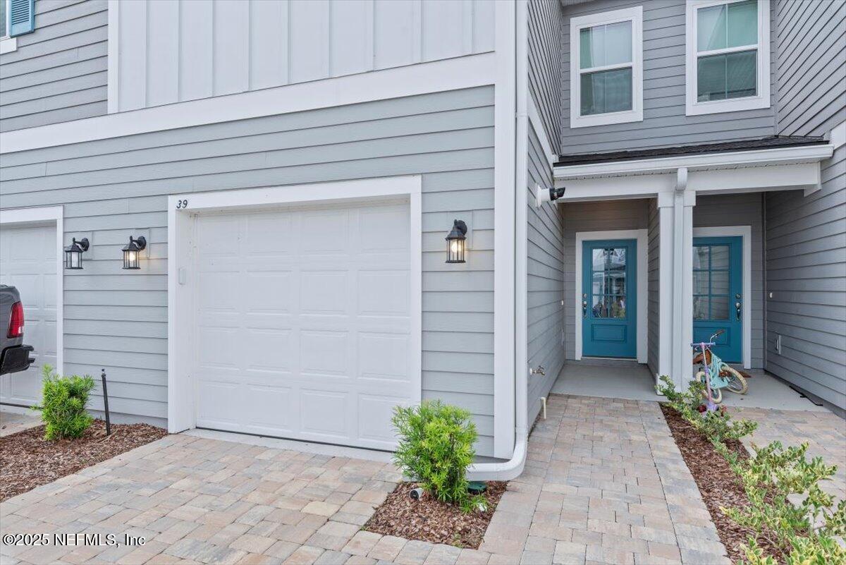 39 Thurnham Lane St. Augustine, FL 32092 - Photo 4 of 52 a view of a pathway of house with potted plants