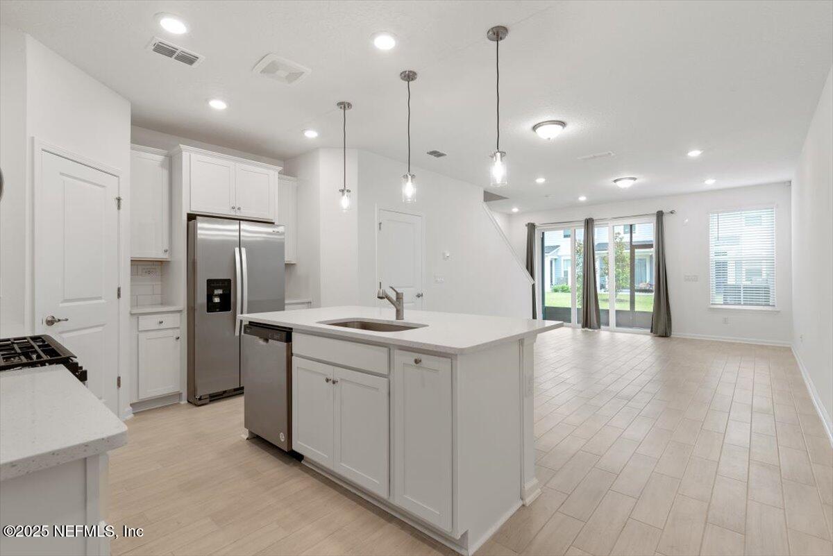 39 Thurnham Lane St. Augustine, FL 32092 - Photo 51 of 52 a large kitchen with a sink a refrigerator and a stove top oven