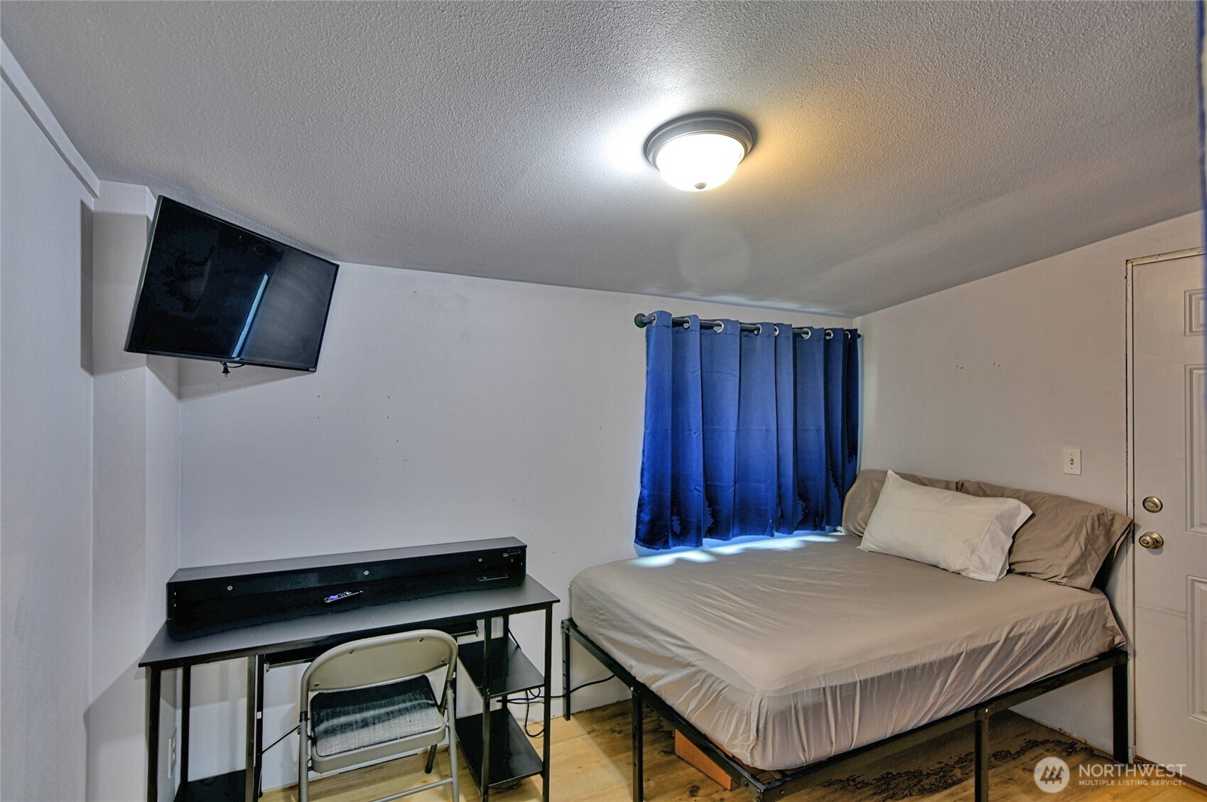 15421 Jim Creek Road Arlington, WA 98223 - Photo 11 of 27 a bedroom with a bed and a television